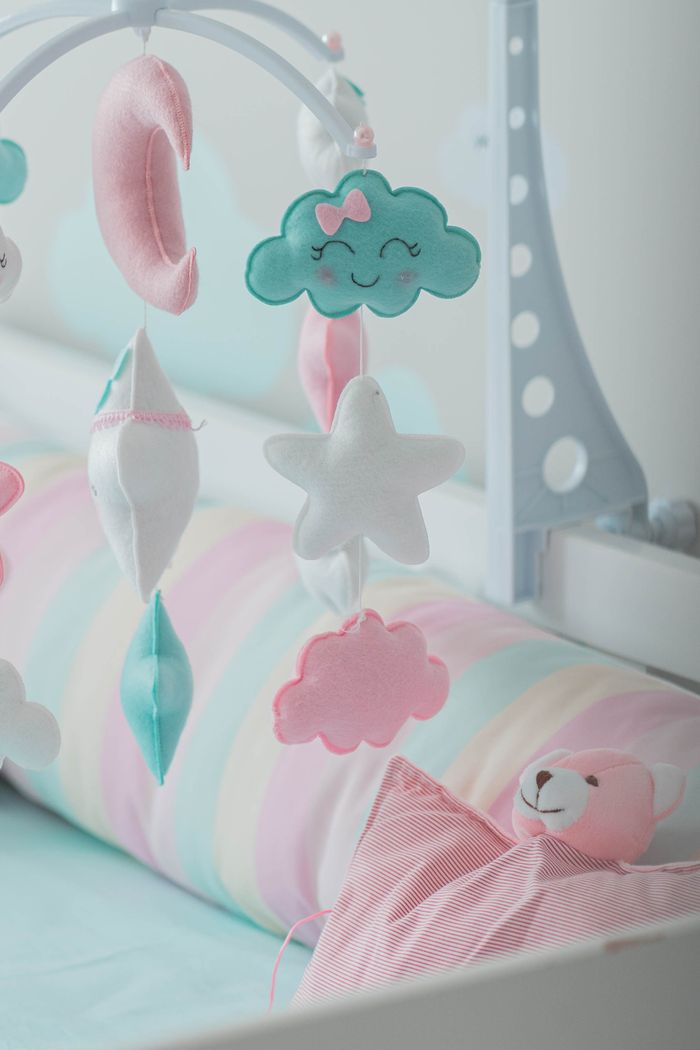 gallery-6 Pastel-themed nursery with a cute mobile and toys, creating a cozy baby atmosphere.