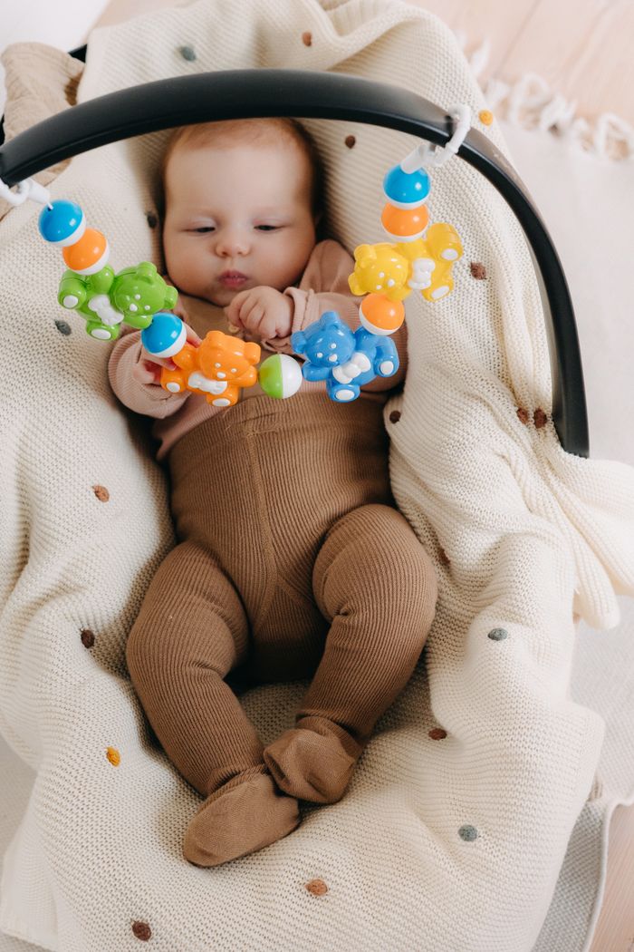 The Art of Drawing Readers In: Your attractive post title goes here Adorable baby enjoying playtime with vibrant toys on a soft blanket indoors.